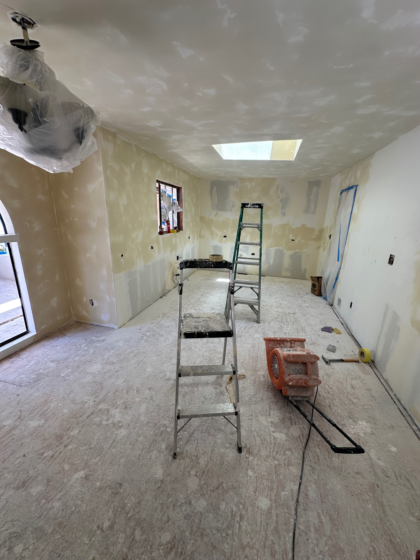Open living space with fully finished drywall walls and ceiling